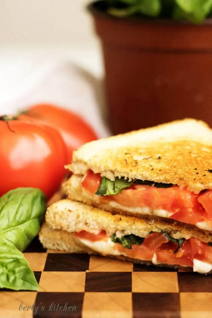 A grilled cheese margarita sandwich with perfectly toasted sourdough and all the flavors of the famous pizza including basil, mozzarella, and tomatoes.