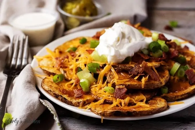 Sliced potato fries topped with cheese, bacon, and sour cream.