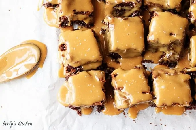 Top down view of fudgy brownies topped with salted caramel sauce.