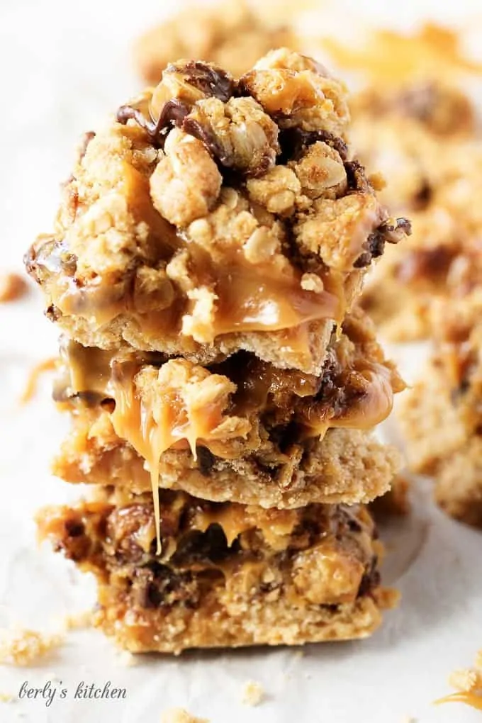 Ooey, gooey, and dripping with caramel, chocolate oat carmelita bars are the way to satisfy any sweet tooth.  who can resist a layer of melted caramel and chocolate sandwiched between a shortbread crust and oatmeal topping?