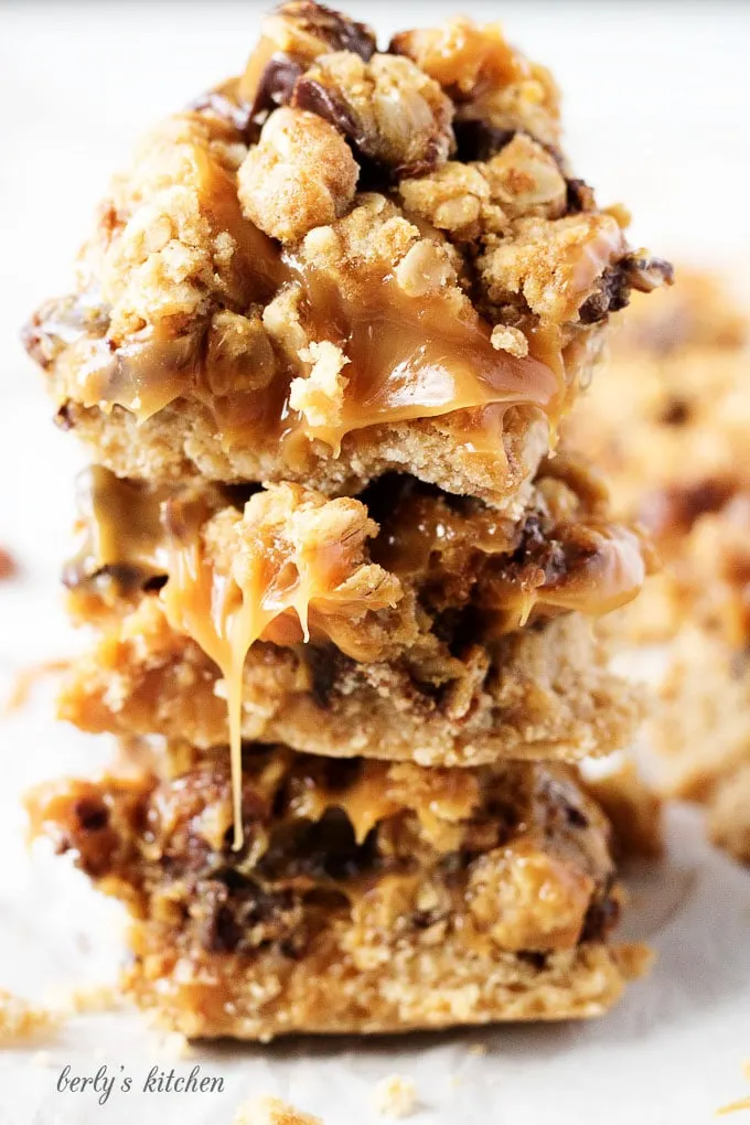 Ooey, gooey, and dripping with caramel, chocolate oat carmelita bars are the way to satisfy any sweet tooth.  who can resist a layer of melted caramel and chocolate sandwiched between a shortbread crust and oatmeal topping?