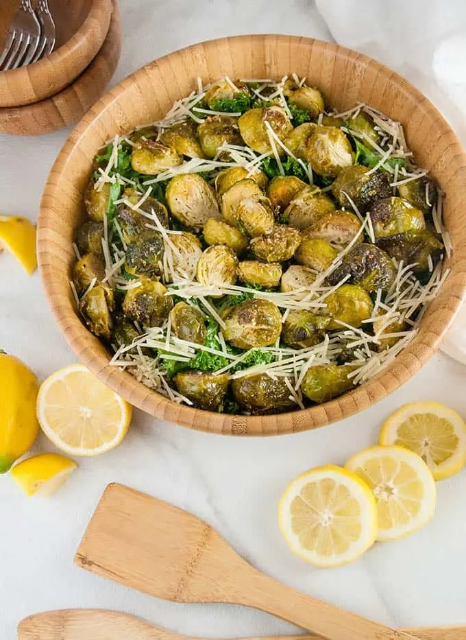 Brussels sprouts caesar salad in a large wooden bowl.