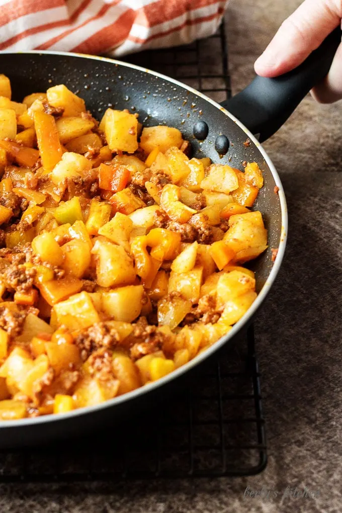 All of the potatoes, peppers, and sausage cooking in a non-stick skillet and are almost done.