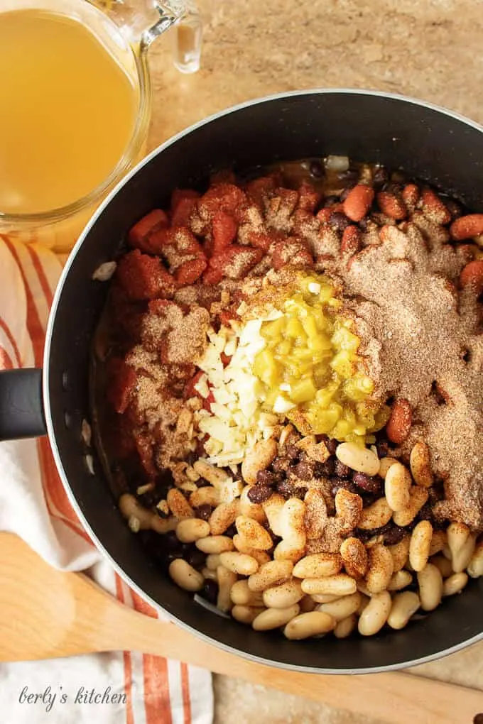 Aerial photo of the three bean chili and spices cooking in a pot.