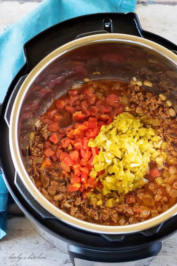 Ariel view of cooked beef, tomatoes, and chiles in an instant pot.