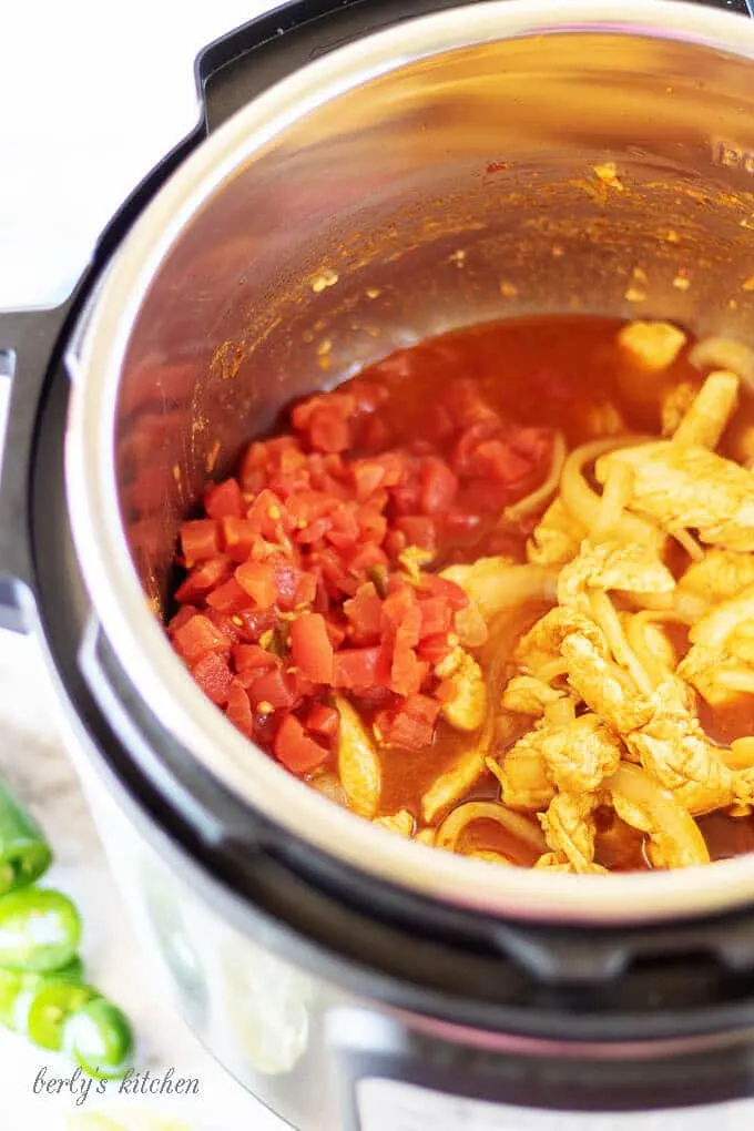 Top-down view of the taco filling cooking in the pressure cooker.