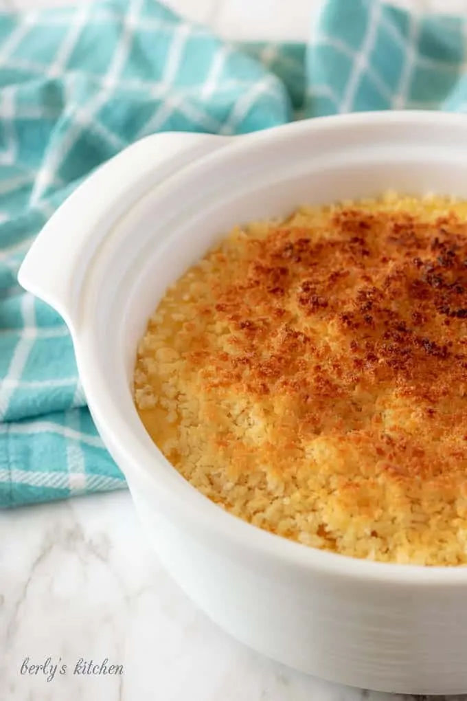 An aerial photo of the funeral potatoes, in a white dish, ready to be served.