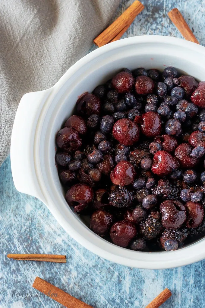 An aerial photo of the berries and spices in the casserole dish,