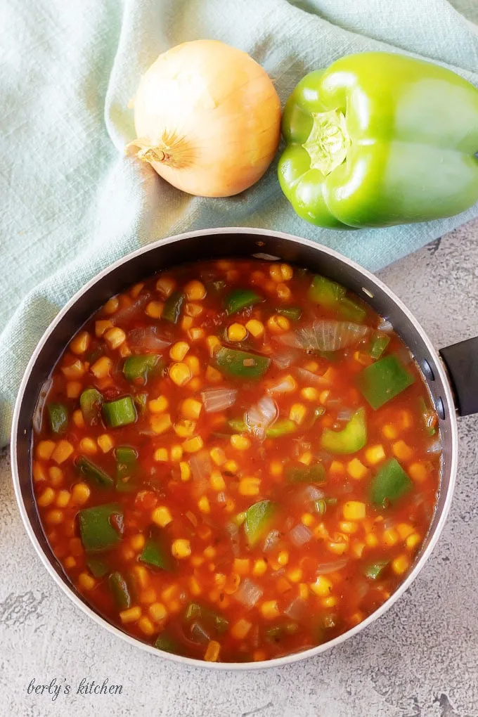 The mexican rice ingredients in a medium saucepan, ready to be cooked.