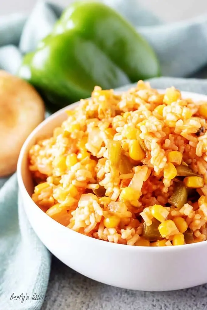 A close-up view of the finished mexican rice in white bowl for serving.