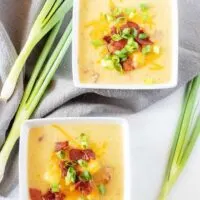 A final top-down picture if the finished instant pot potato soup with bacon served in two squares bowl.