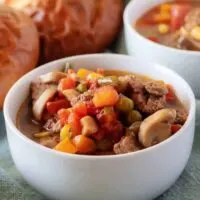 A close-up view of the finished vegetable beef soup in white bowl.