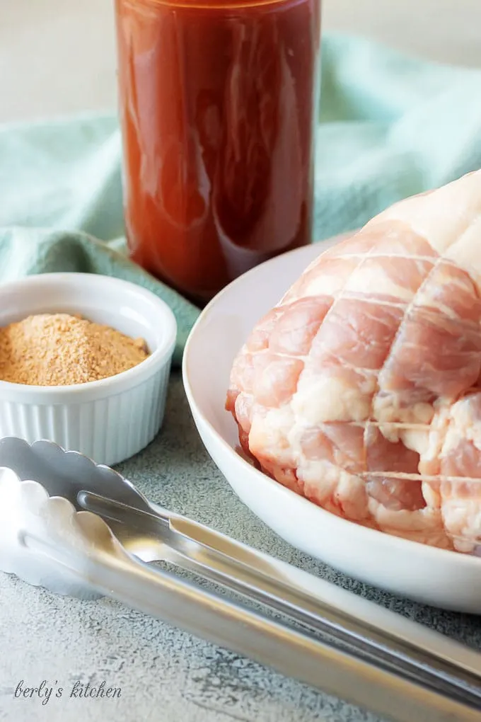 The pulled pork sandwich ingredients, like the rub and the homemade bbq sauce, prepped and ready to be cooked.