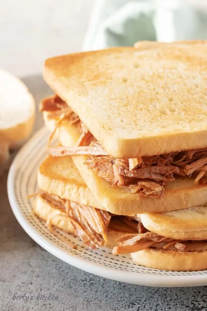 A close-up photo of the slow cooker pulled pork on toasted bread.