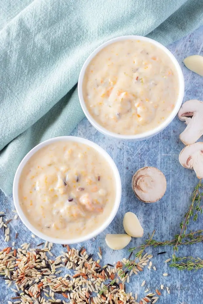 A top-down view of the finished instant pot soup served in small white bowls highlighted with fresh garlic.