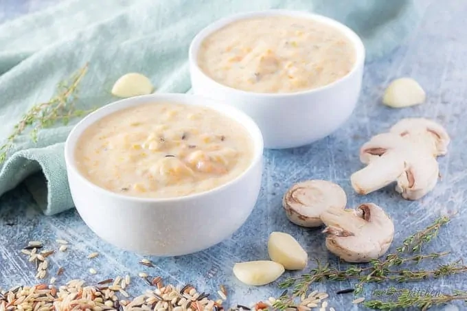 The finished instant pot soup loaded with wild rice and fresh mushrooms served in white bowls.