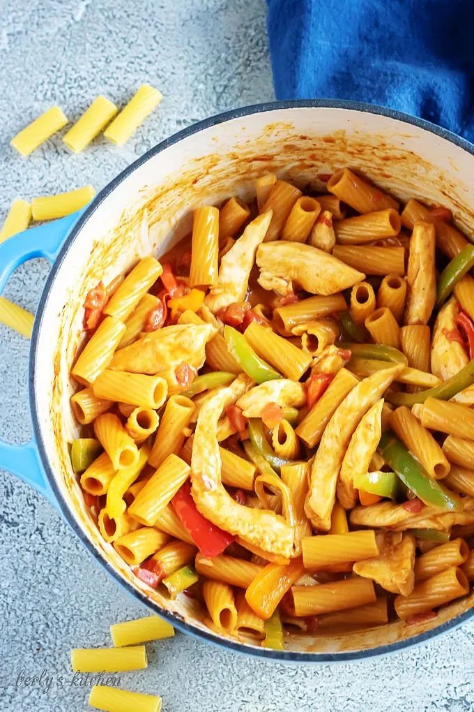 Arial view of pasta, chicken, and veggies in a dutch oven.