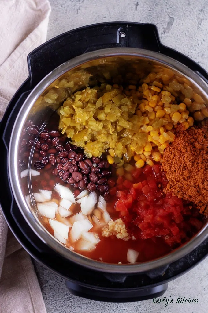 The top-down picture shows the black bean ingredients inside of the pressure cooker, ready to be sealed and cooked.