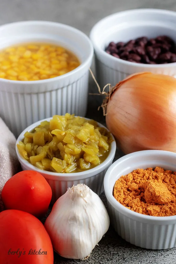 The photo shows the black bean chili ingredients like, beans, corn, tomatoes, garlic, and taco seasoning.