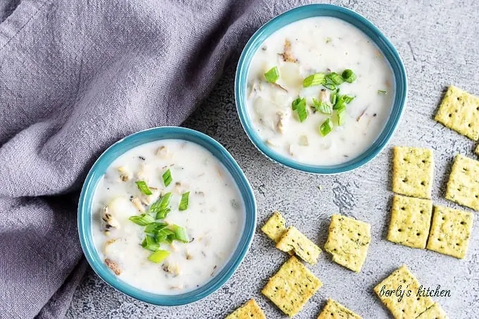 An aerial shot of the clam chowder in bowls, topped with green onion.