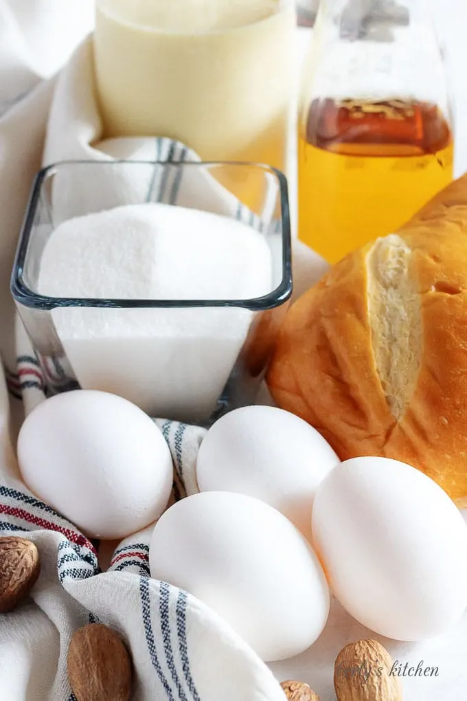 The bread pudding with rum sauce ingredients like eggs, sugar, and a loaf of french bread.