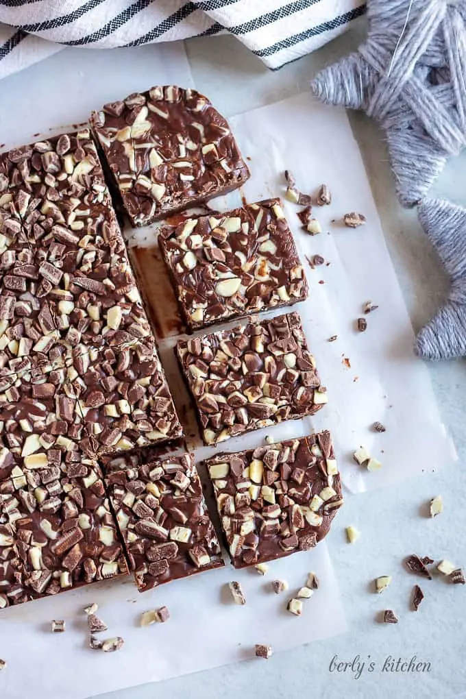 The fudge has set and has been cut into large squares.