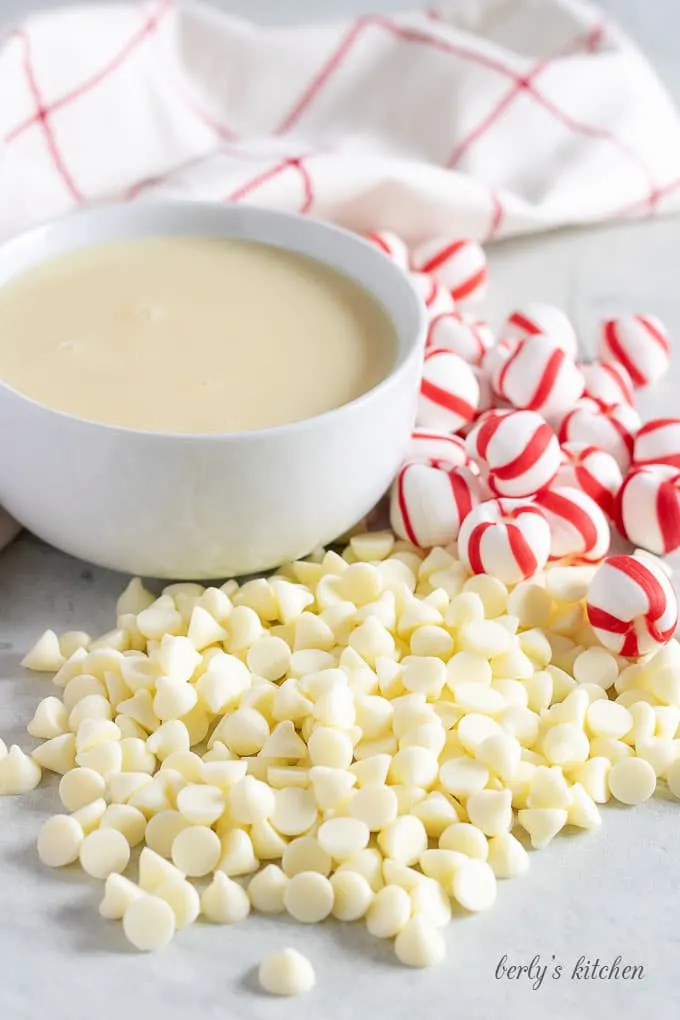 The fudge ingredients, including peppermint candy, sweetened condensed milk, and white chocolate chips.