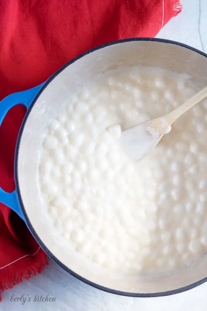 Top down view of melted marshmallows and butter in a pan used for rice krispie treat recipe..