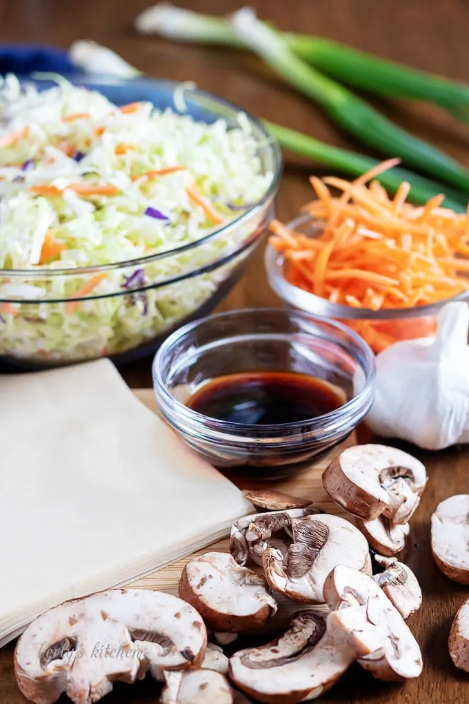 The homemade egg roll ingredients, like garlic, slaw, carrots, and ginger.