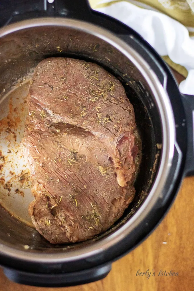 The roast being seared while the pressure cooker before adding vegetables.