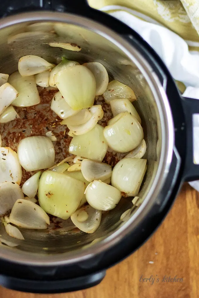 The roast is done searing and is now covered with onions.