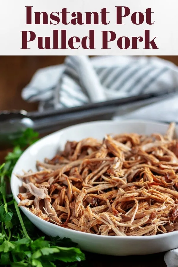 The pulled pork has been placed in a white dish for serving.