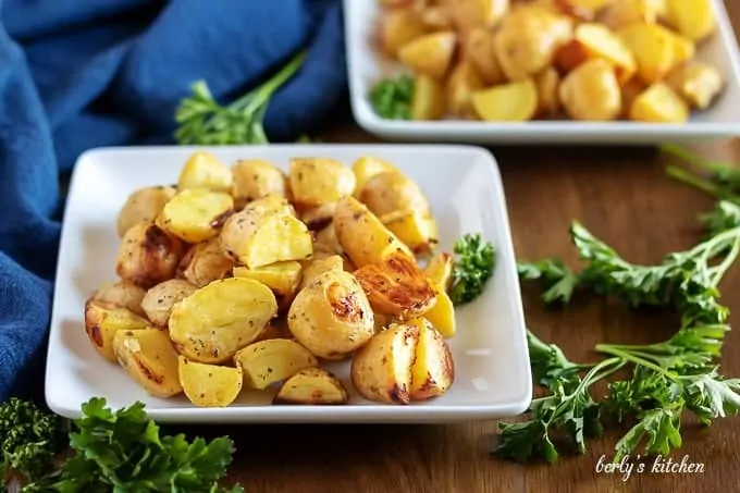 The ranch potatoes, garnished with parsley, sitting in a square dish.