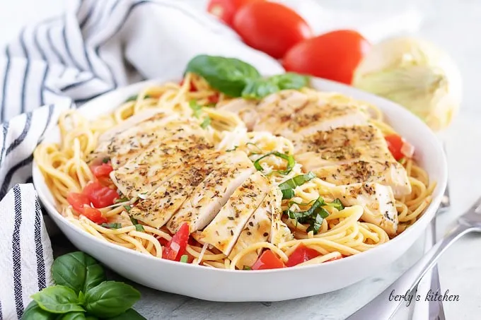 A large pasta bowl filled with the buschetta chicken pasta.