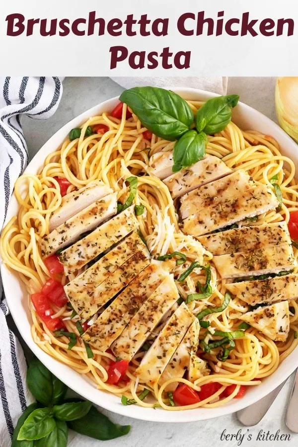 Overhead photo of the bruschetta chicken pasta, served with fresh basil.