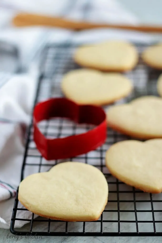 Baked cut out sugar cookies on a cooling rack.