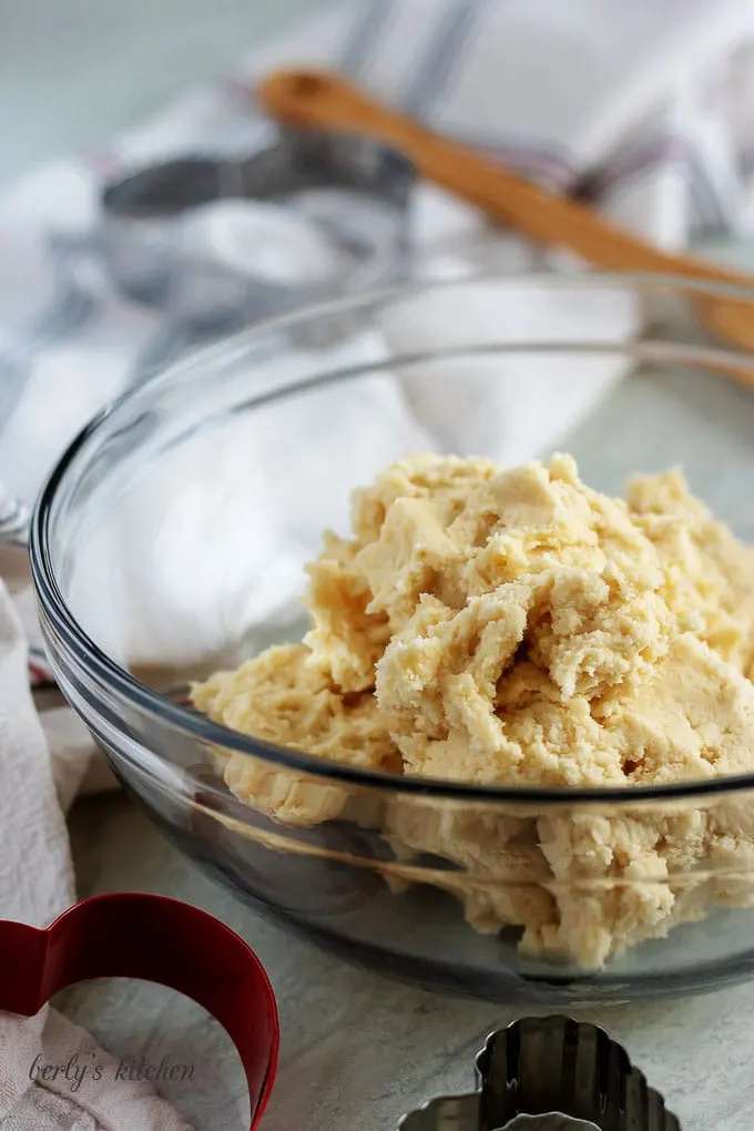 Cut out sugar cookie recipe dough in a glass bowl.