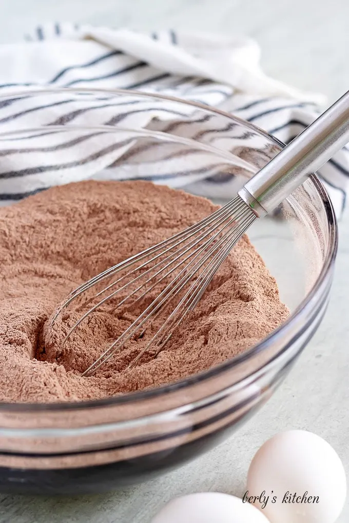 The dry ingredients have been sifted into a mixing glass bowl.