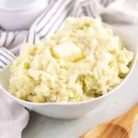 The colcannon has been placed in a bowl and garnished with butter.