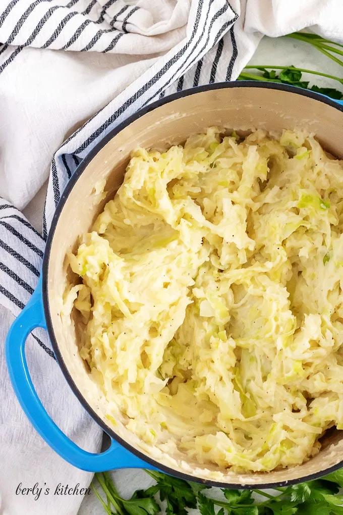 The potatoes have been mashed and the fried cabbage has been added.