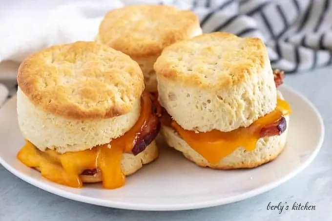 Three cheesy ham biscuits stuffed with salted ham and melted cheddar cheese.