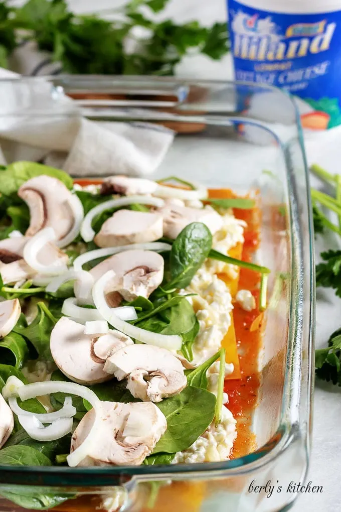 Sliced mushrooms, spinach, and onions, layered over cottage cheese filling.