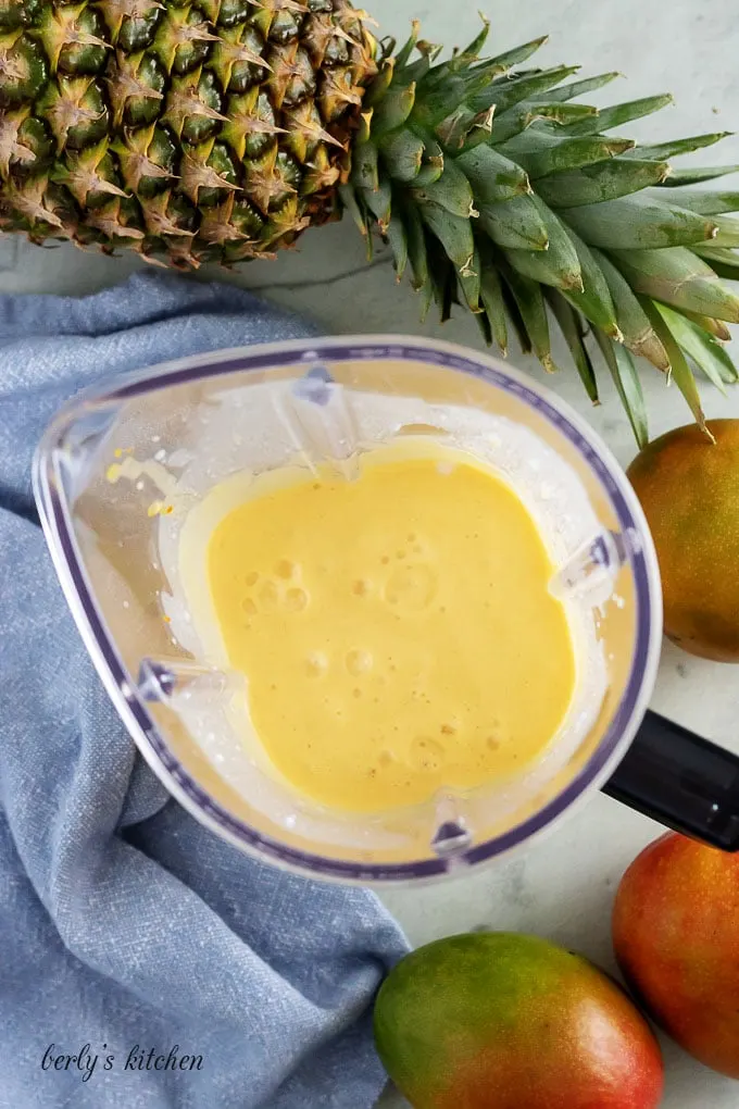 An aerial view of the pineapple mango smoothie in the blender.