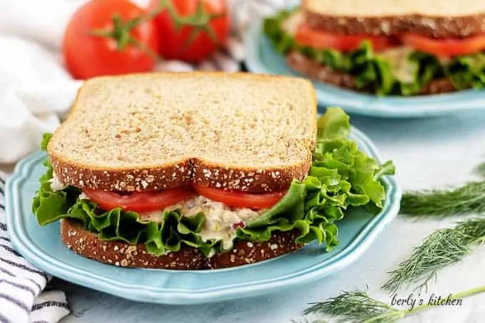 The tuna salad sandwich served on wheat bread with lettuce and tomato.