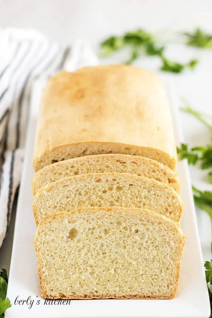 The finished english muffin bread on a rectangular plate.