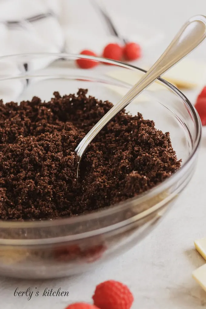 Bowl of chocolate graham cracker crumb mixture used for instant pot white chocolate raspberry cheesecake.