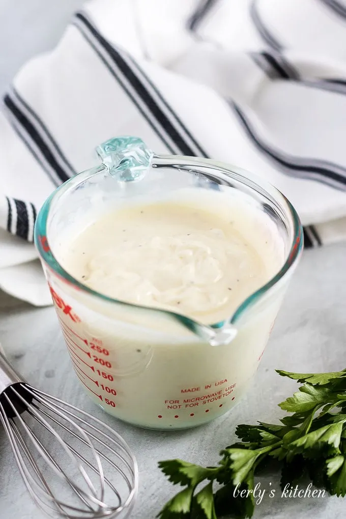 The salad dressing has been mixed in a sixteen ounce measuring cup.