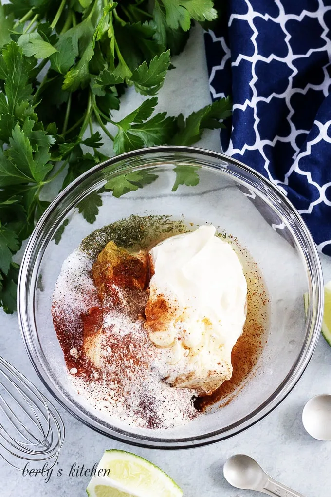 All of the ingredients have been added to a large glass bowl.