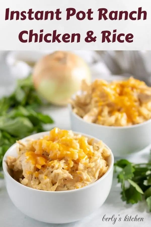 Two bowls of instant pot ranch chicken and rice topped with cheese.