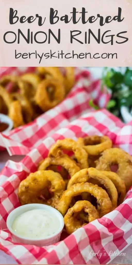 Two baskets of beer battered onion rings served with ranch dressing.